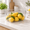 Medium clear pantry and fridge storage tub with lemons on a kitchen countertop