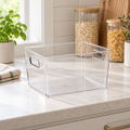 Empty large clear pantry and fridge storage tub on a bright kitchen countertop