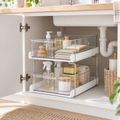 Two-tier clear under-sink organising drawers inside an open bathroom cabinet