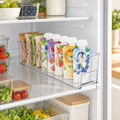 Clear small fridge storage tray holding snack pouches on a refrigerator shelf