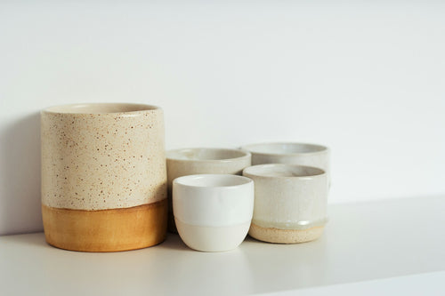Open pantry with matched glass jars and bamboo lids